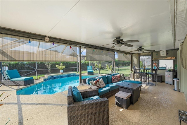 view of pool featuring ceiling fan, an outdoor living space, a lanai, and a patio