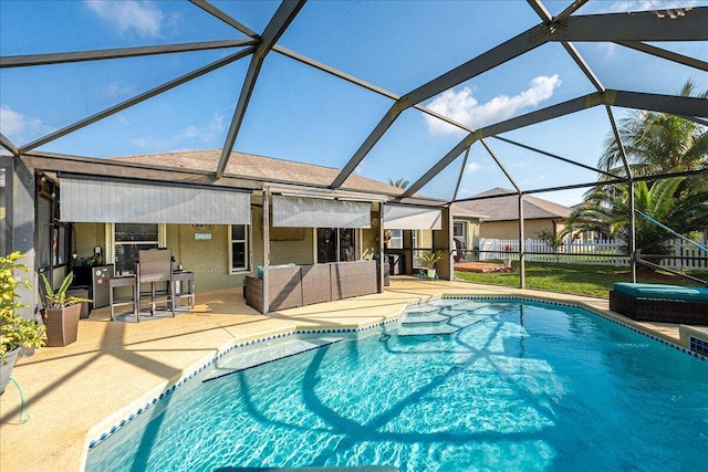 view of swimming pool featuring an outdoor hangout area, glass enclosure, and a patio area