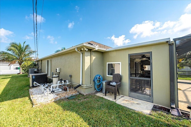 back of property with a yard and cooling unit