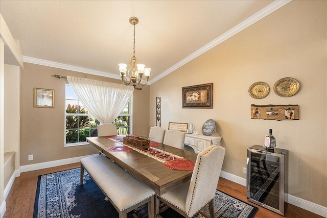 dining space featuring vaulted ceiling, beverage cooler, a chandelier, hardwood / wood-style flooring, and crown molding