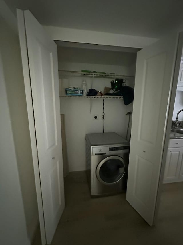 laundry room featuring washer / dryer and sink