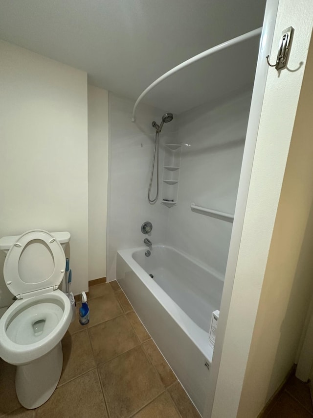 bathroom featuring toilet, tub / shower combination, and tile patterned flooring