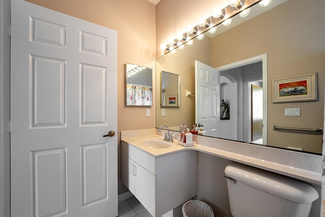 bathroom with vanity, tile patterned floors, and toilet