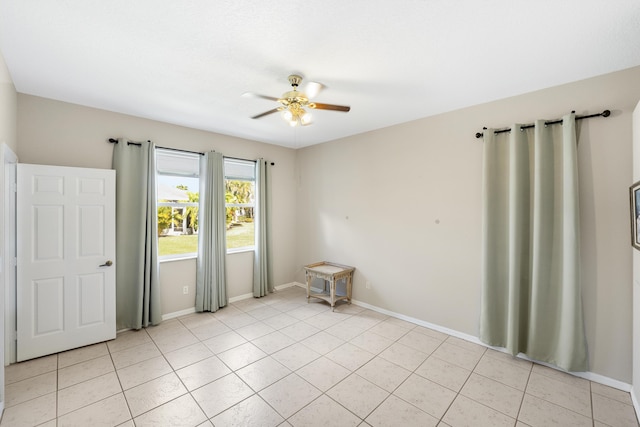 spare room with light tile patterned floors and ceiling fan