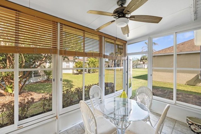 unfurnished sunroom with a ceiling fan