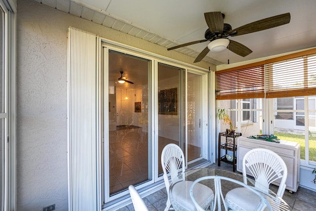 sunroom / solarium with a ceiling fan