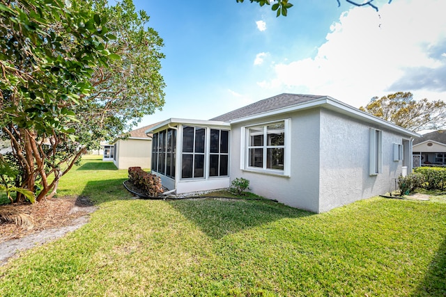 rear view of property with a sunroom and a yard