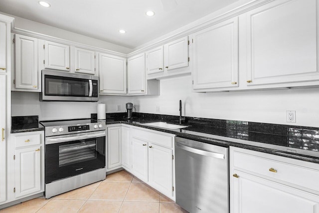 kitchen with white cabinetry, stainless steel appliances, and sink