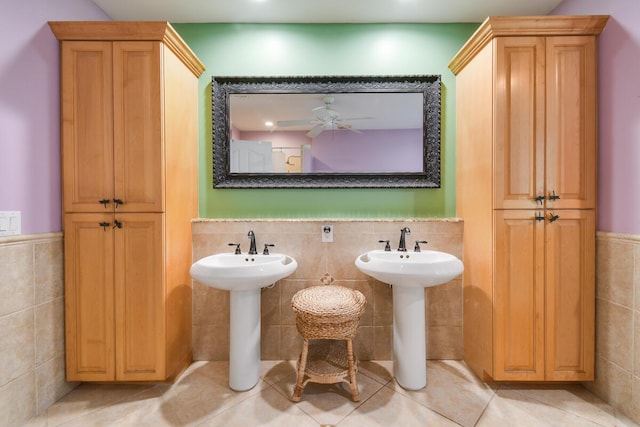 bathroom with a wainscoted wall, tile patterned flooring, ceiling fan, and tile walls