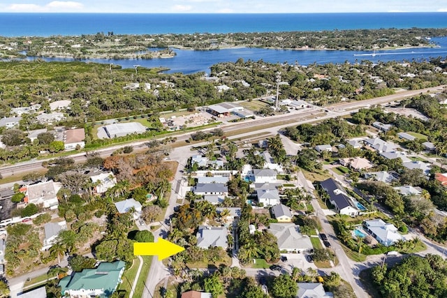 drone / aerial view with a water view and a residential view