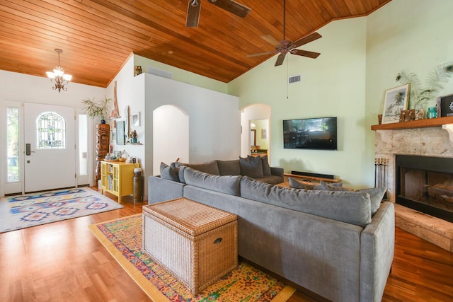 living area featuring arched walkways, wood finished floors, and wood ceiling