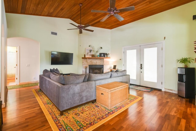 living room featuring visible vents, arched walkways, wood ceiling, wood finished floors, and french doors