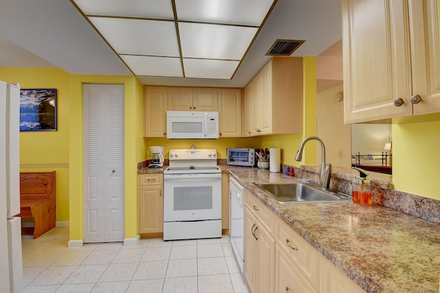 kitchen featuring white appliances, light tile patterned floors, sink, and light brown cabinets