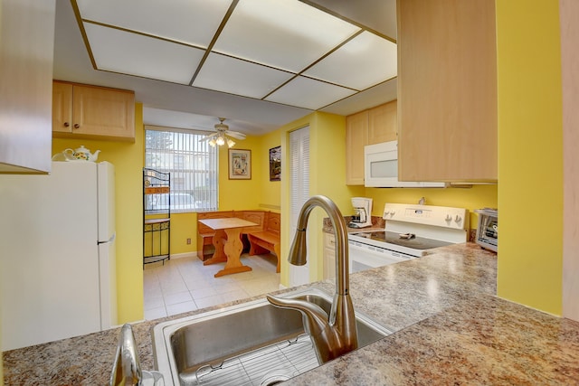 kitchen with sink, white appliances, ceiling fan, light tile patterned flooring, and light brown cabinets