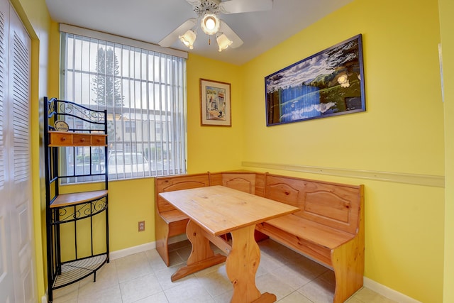 tiled dining area featuring ceiling fan and breakfast area