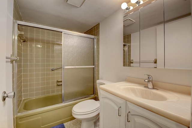 full bathroom featuring bath / shower combo with glass door, vanity, and toilet