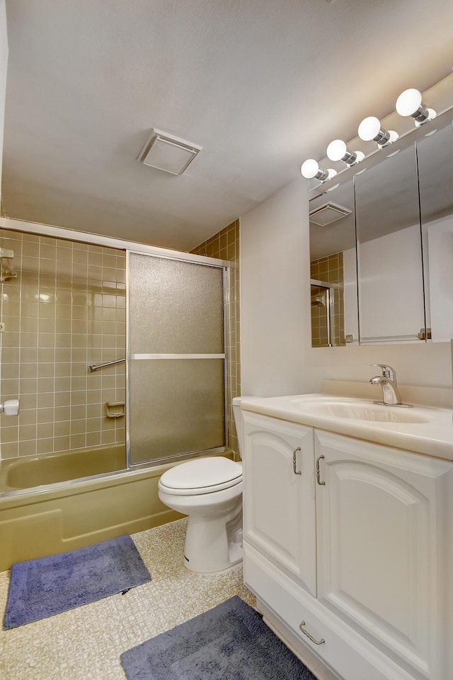 full bathroom featuring vanity, enclosed tub / shower combo, and toilet