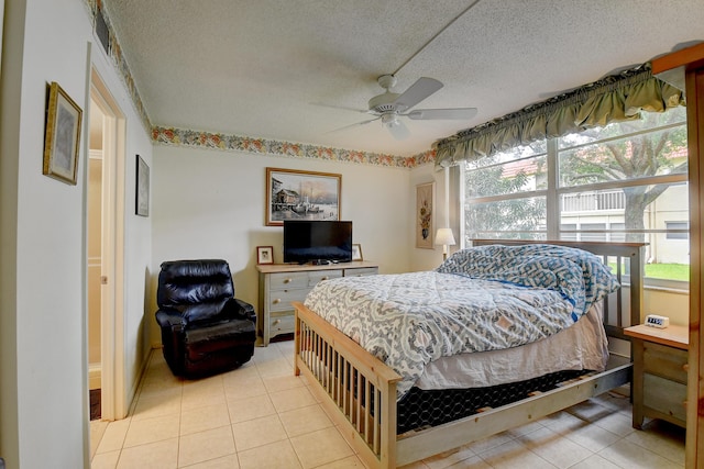 bedroom featuring ceiling fan, a textured ceiling, and light tile patterned floors