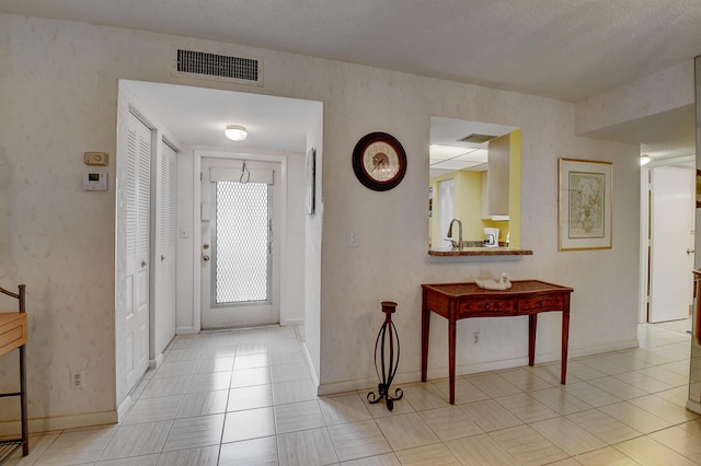 foyer with light tile patterned floors