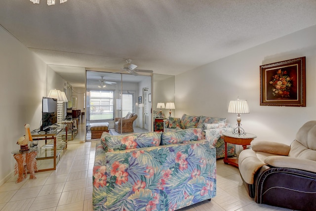 tiled living room featuring ceiling fan and a textured ceiling