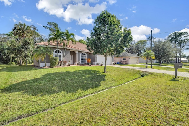 view of front of house with a garage and a front lawn