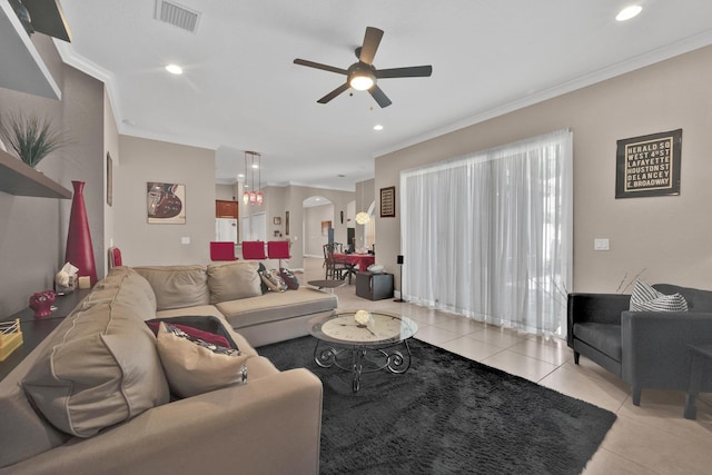 living room featuring crown molding, ceiling fan, and light tile patterned floors