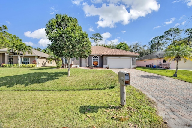 ranch-style home featuring a garage and a front yard