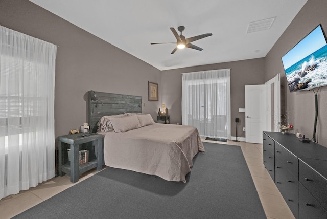 tiled bedroom featuring ceiling fan