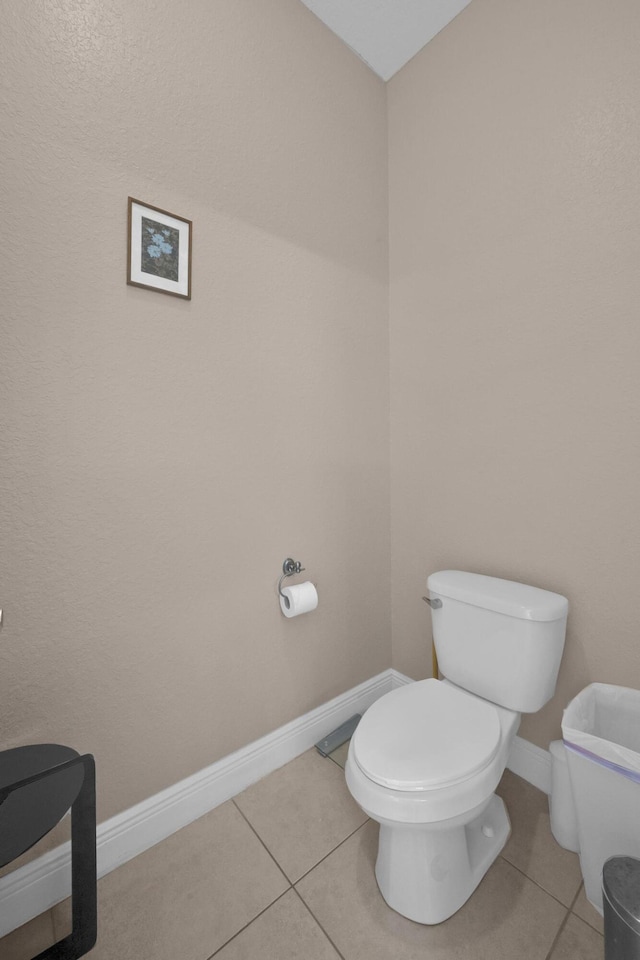 bathroom featuring toilet and tile patterned flooring