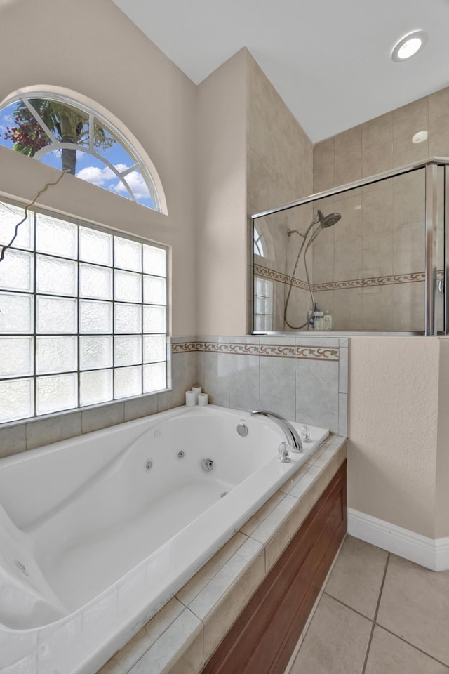 bathroom with tile patterned flooring, plus walk in shower, and a wealth of natural light