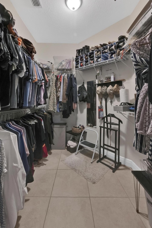 walk in closet featuring light tile patterned flooring