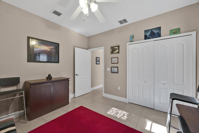 office featuring light tile patterned floors and ceiling fan