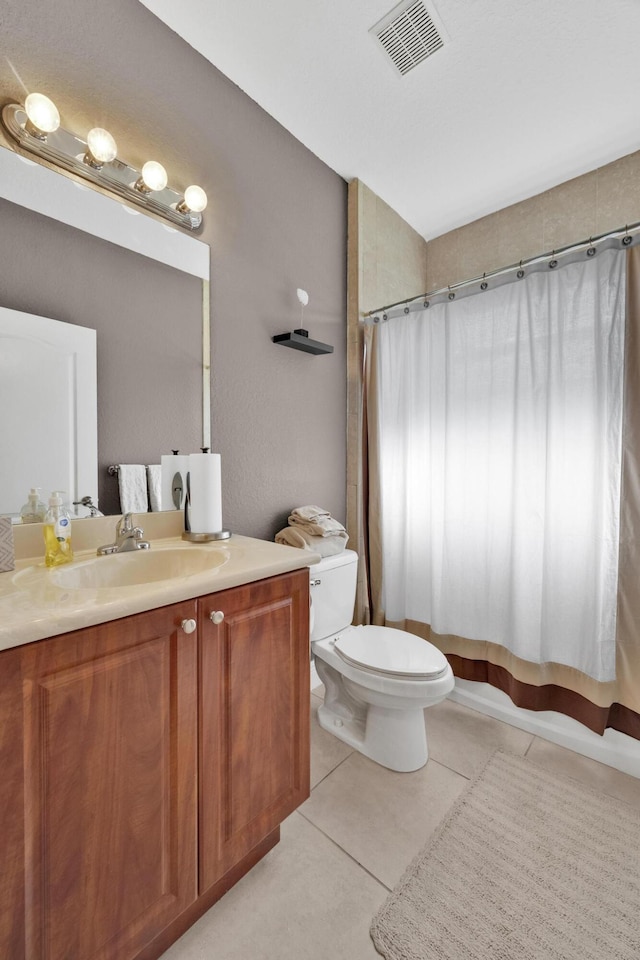 bathroom with vanity, tile patterned floors, and toilet