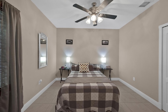 tiled bedroom with ceiling fan