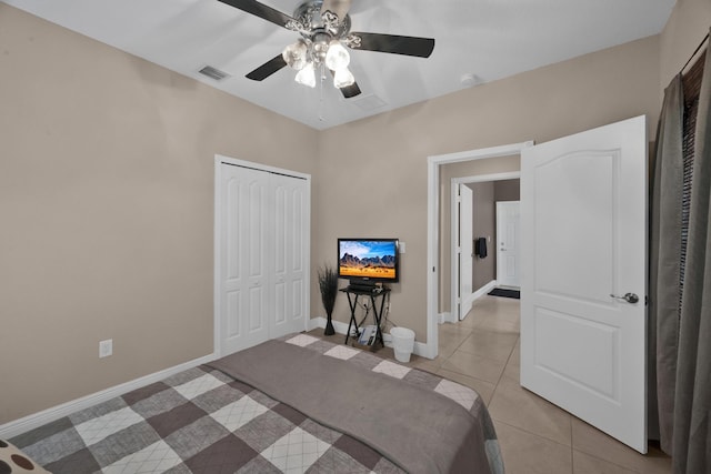 tiled bedroom with a closet and ceiling fan