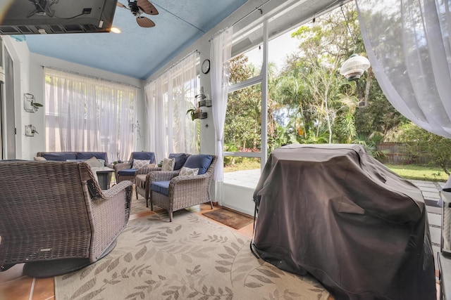 sunroom featuring ceiling fan