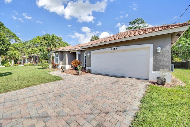 mediterranean / spanish-style home with a garage and a front yard