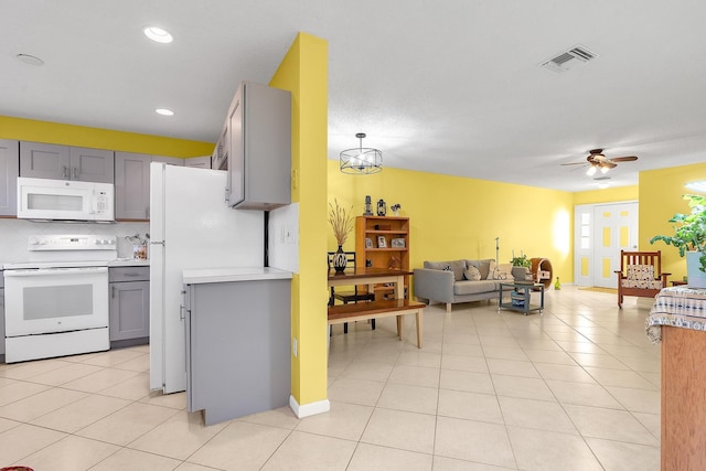 kitchen featuring white appliances, gray cabinets, decorative backsplash, and light tile patterned floors