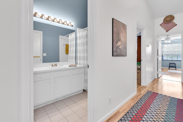 bathroom featuring ceiling fan, vanity, and hardwood / wood-style floors