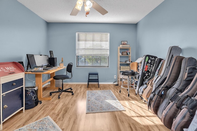 office area with ceiling fan, wood-type flooring, and a textured ceiling