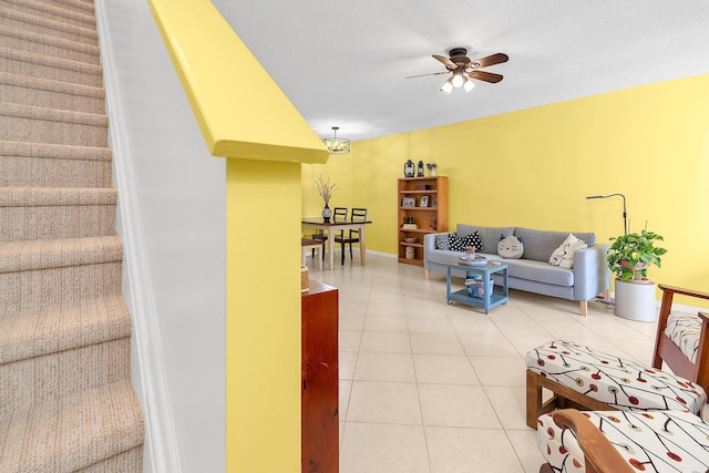 living room with ceiling fan and tile patterned floors