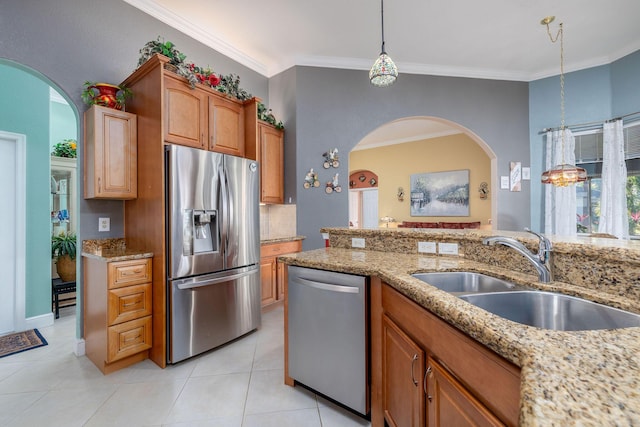 kitchen featuring light stone counters, light tile patterned floors, backsplash, appliances with stainless steel finishes, and a sink