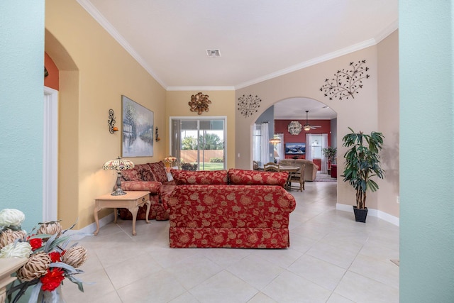 living area featuring arched walkways, ornamental molding, visible vents, and baseboards