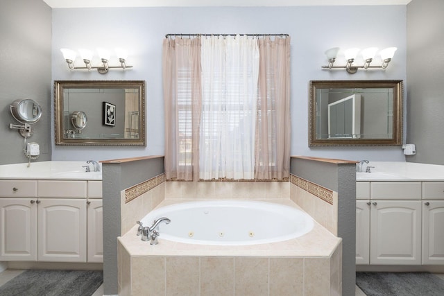 bathroom featuring two vanities, a sink, and a jetted tub