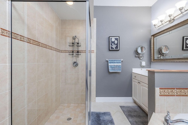 full bathroom with tile patterned flooring, baseboards, a shower stall, and vanity