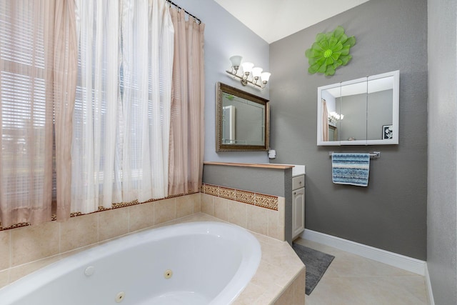 bathroom featuring baseboards, a tub with jets, vanity, and tile patterned floors