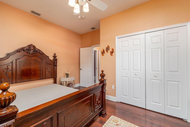 bedroom with baseboards, a closet, visible vents, and dark wood-style flooring