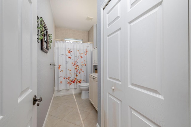 full bath featuring baseboards, toilet, tile patterned floors, shower / bath combination with curtain, and vanity