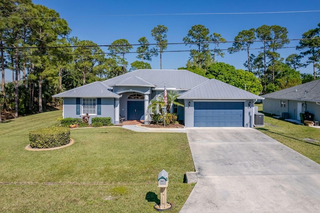 single story home featuring a garage, metal roof, a front lawn, and driveway