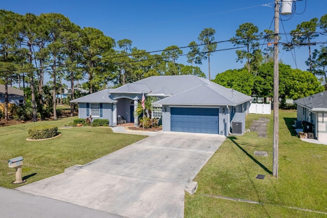 ranch-style home featuring a garage, driveway, metal roof, cooling unit, and a front yard